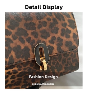 Macro shot of leopard print leather texture and black gold metal turn-lock on the bag