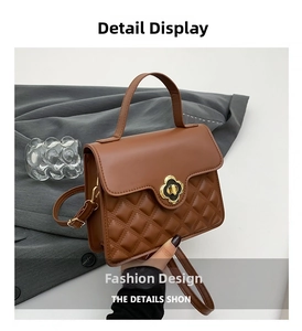 Detail of brown quilted crossbody bag featuring a golden floral twist lock and elegant texture