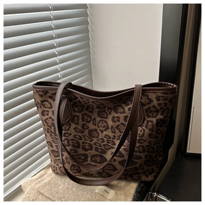 Vue détaillée du cabas à imprimé léopard avec bandoulière en cuir sur tissu doux