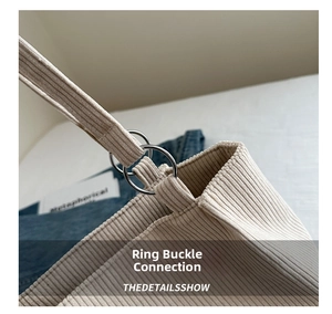 Detailed close-up of corduroy fabric texture and silver metal ring buckle connection