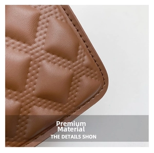 Detail of brown quilted leather texture featuring classic rhombus stitching and lychee grain