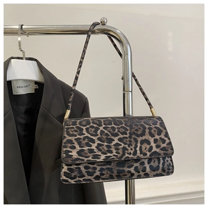 Close-up of leopard print shoulder bag featuring gold hardware and vintage texture