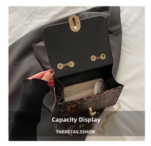 Interior view of leopard print chain bag showing storage space and gold turn-lock