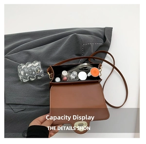 Internal storage view of the brown leather crossbody bag with daily essentials inside
