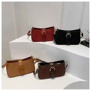 Detail of four matte leather handbags in red, black, camel and coffee with metal rings