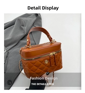 Detail of vintage brown quilted bag with gold camellia hardware and chain strap
