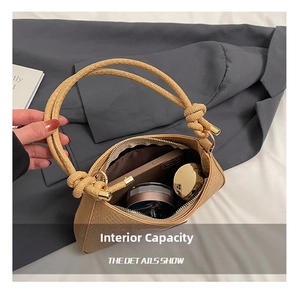 Detail showing the internal capacity of the khaki woven hobo bag with knotted handle