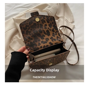 Détail du sac bandoulière léopard montrant l'espace pour téléphone et portefeuille