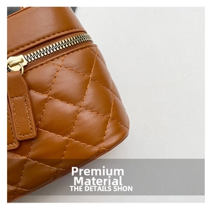 Macro shot of brown quilted leather texture with gold metal zipper and neat stitching
