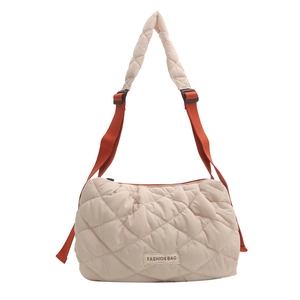 Quilted puffer tote bag in cream white with adjustable bright orange shoulder strap