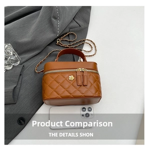 Detail view of brown quilted bucket bag with 3D flower charm and gold chain strap