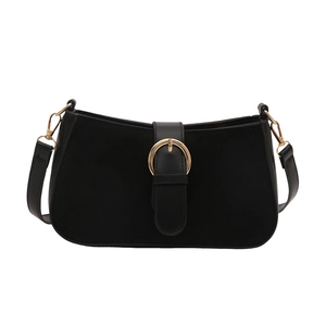 Minimalist black matte shoulder bag with a gold buckle and adjustable leather strap