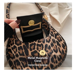 Detail of the leopard print crescent bag featuring a secure golden magnetic metal clasp