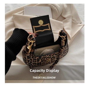 Macro shot showing internal capacity of leopard print bag with phone and cosmetics