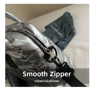 Details der silbernen Metallic-Stepptasche mit Hochglanz-Finish und glattem Reißverschluss