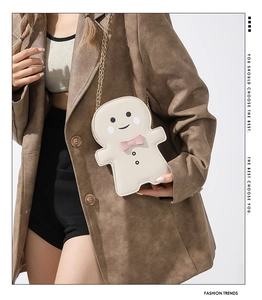 Detail of cute gingerbread man crossbody bag with cream PU leather and gold chain strap