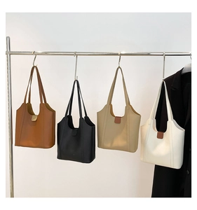 Detail view of large capacity tote bags in brown, black, khaki, and white finishes
