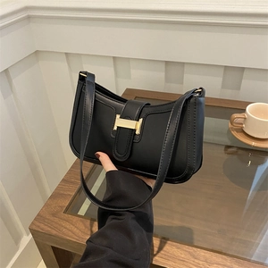 Classic black shoulder bag with golden H buckle and matte leather finish for casual style