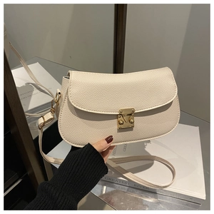 Detailed macro of creamy white pebble leather texture and gold metal buckle clasp