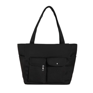 Black large capacity tote bag with front pockets and wide shoulder straps on white background