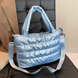 Metallic light blue quilted puffer tote bag with adjustable strap for daily commute