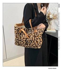 Detail of leopard print faux fur tote bag with brown leather handles and large interior