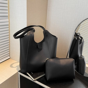 Minimalist black faux leather tote bag set with small zipper pouch for daily commuting