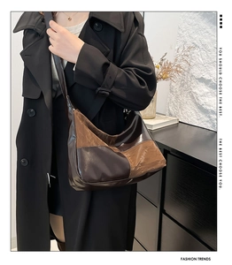 Detail of a vintage two-tone patchwork leather hobo bag with a wide adjustable shoulder strap