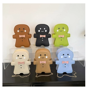 Detail view of colorful gingerbread man shaped crossbody bags with gold chain straps
