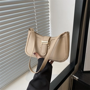 Elegant apricot faux leather shoulder bag with golden buckle and curved minimalist design