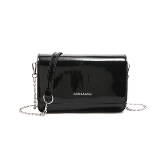 Glossy black patent leather rectangular crossbody bag with silver chain and white logo