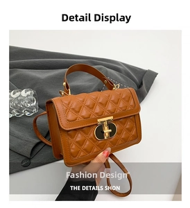 Close-up of brown quilted leather bag with elegant gold T-clasp and sturdy top handle