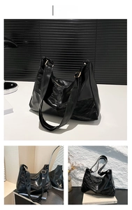 Detail view of black patchwork tote bag with pleated texture and gold hardware