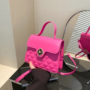Magenta quilted crossbody bag with golden clover clasp and top handle for women