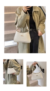 Detail of beige underarm bag featuring woven texture and golden metal hardware