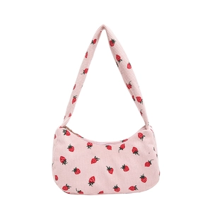 Pink corduroy shoulder bag with strawberry print and zipper closure for casual use