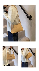 Detail of apricot textured shoulder bag with knot strap and gold metal hardware
