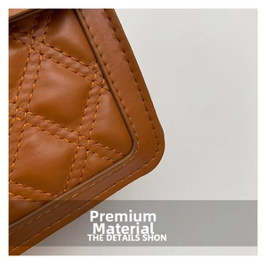 Detailed close-up of brown quilted leather texture and fine stitching on the shoulder bag