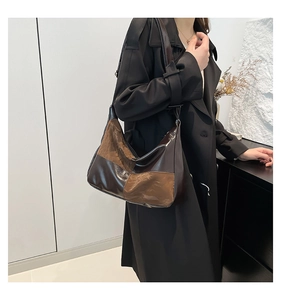 Detailed view of brown contrast paneling and premium PU leather texture on tote bag