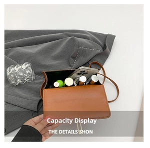 Internal view of brown leather bag showing capacity for phone and cosmetics