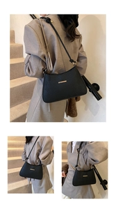 Detail of black woven texture shoulder bag featuring gold metallic bar hardware
