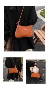 Detail view of orange woven shoulder bag with golden buckle and knot strap detail