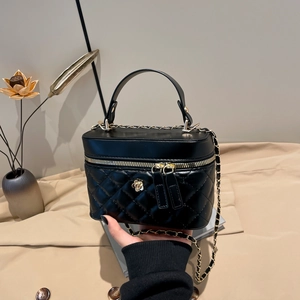 Chic black quilted chain crossbody bucket bag with golden camellia floral buckle