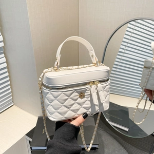 Elegant white quilted crossbody bucket bag with gold chain strap and floral detail