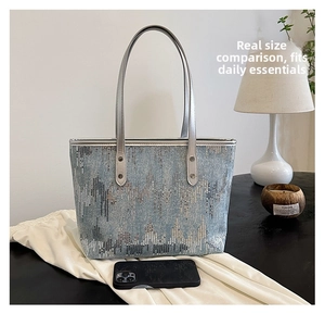 Detail of glitter sequins tote bag with silver handles and studs for work