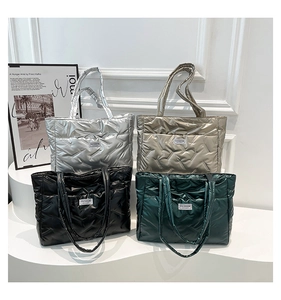 Quilted tote bags in silver, gold, black, and green with glossy metallic textures