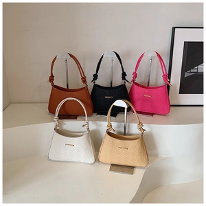 Detailed collection of woven underarm bags in five colors with metal bar accents