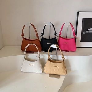 French minimalist textured shoulder bags in brown, black, and white with knot handle detail