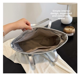 Detail of the silver tote bag interior featuring large capacity and multiple compartments