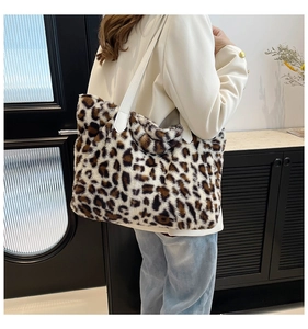 Detailed view of fashionable leopard print faux fur tote bag with white leather strap